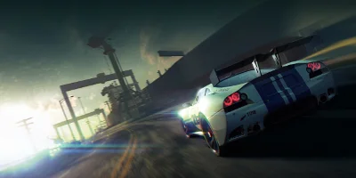 A white & blue super-car, speeding down a motorway