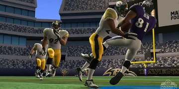 A player in white and yellow, taking down a player dressed in blue as his team-mates come to help