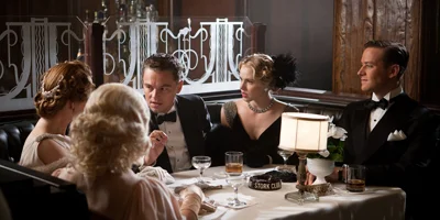 Still of Leonardo DiCaprio Sat at Table with Friends