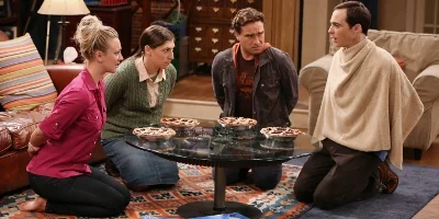 Penny, Amy, Sheldon and Leonard Gathered around a table